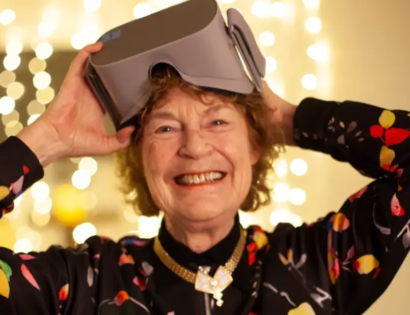 older person taking off VR Headset