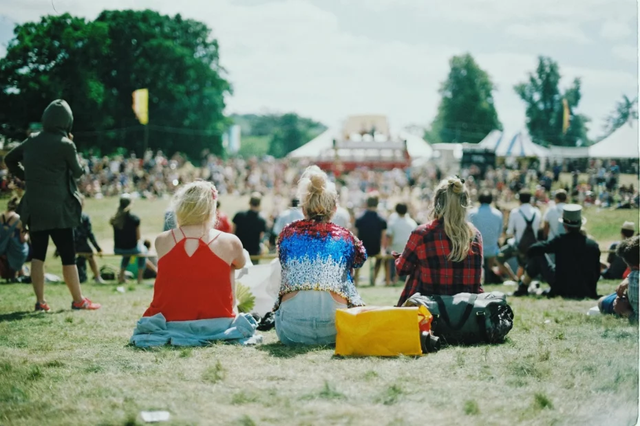 festival crowd sat on ground in sun