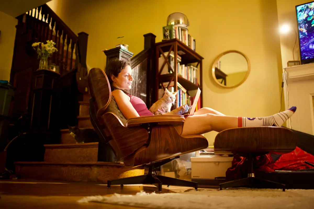 Woman relaxing watching her laptop. With a cat
