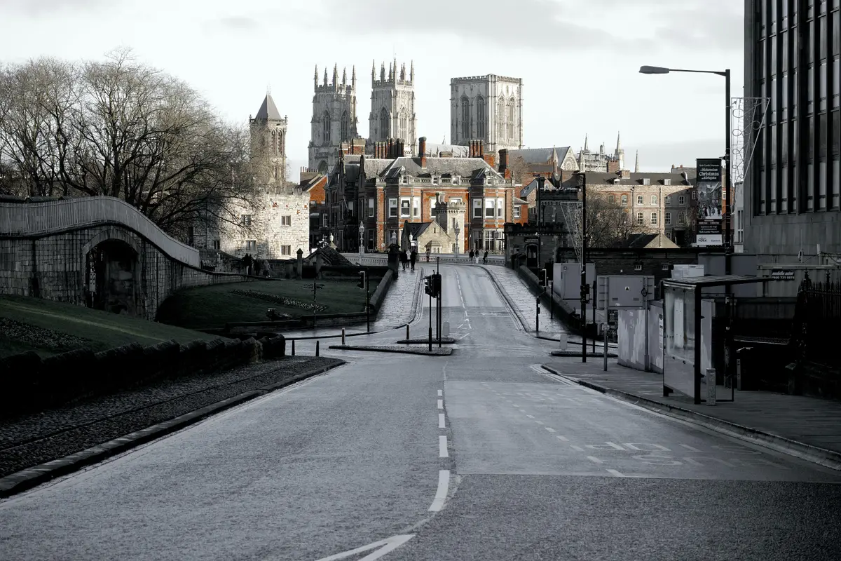 city street scene with empty road and cathedral in background