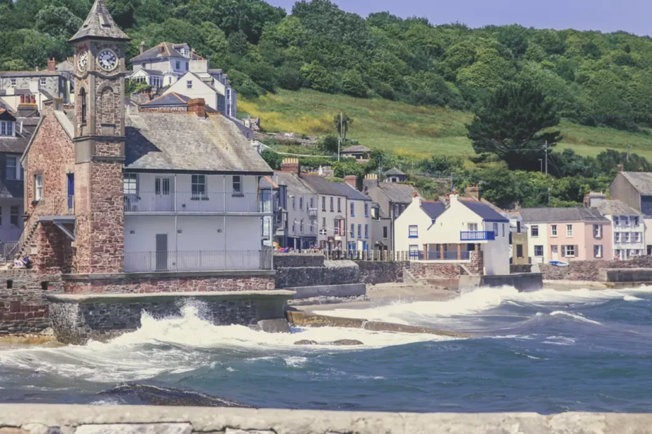 coastal village scene with waves lapping sea wall