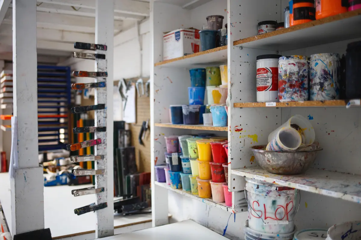 artist studio shelves with paint pots