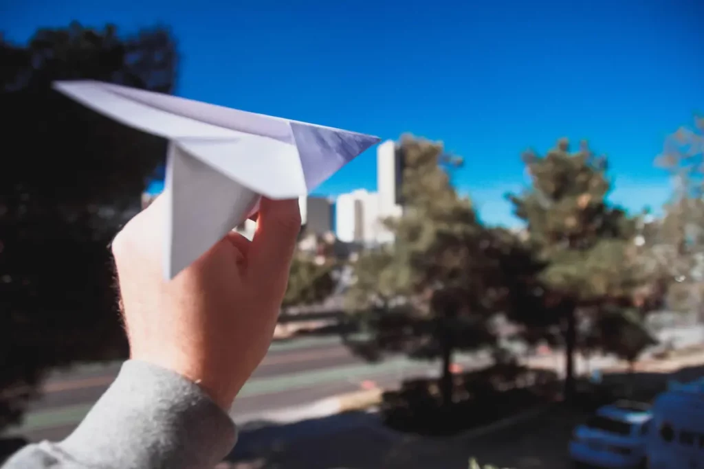 Person throwing paper areoplane
