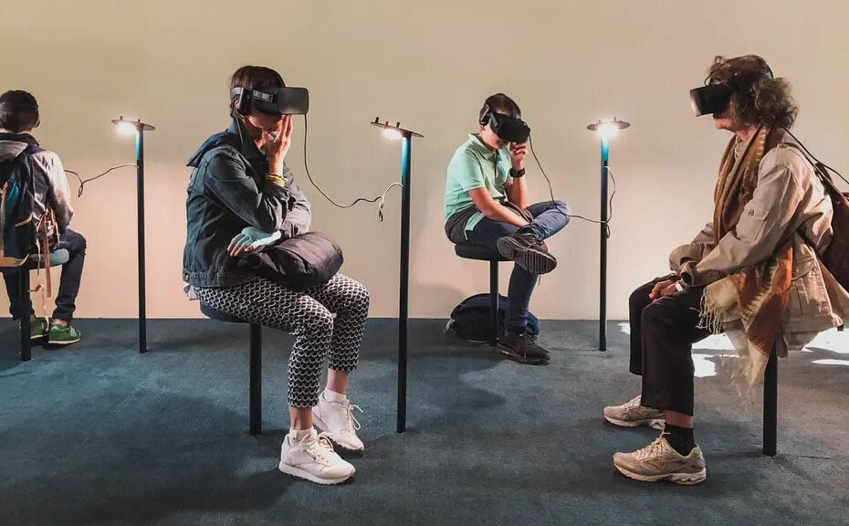 people sat in art gallery wearing VR Headsets