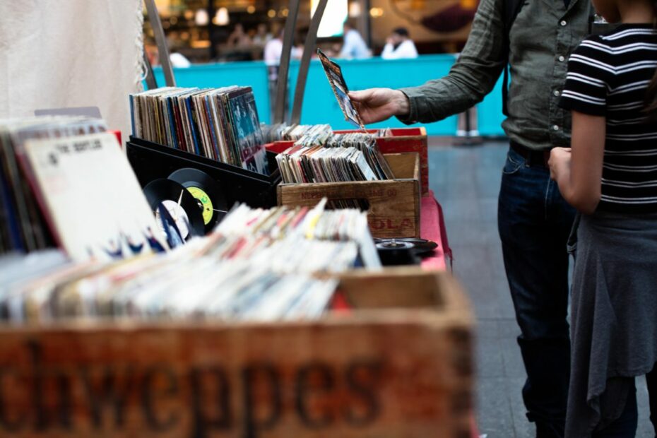 image of person sifting through box of vinyl records