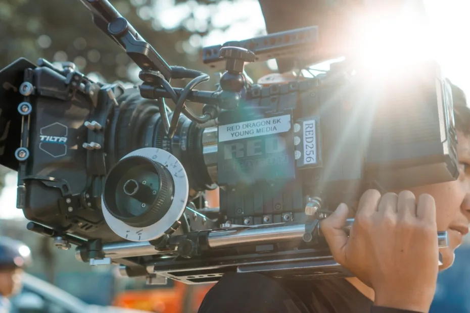 camera person carrying camera on shoulder