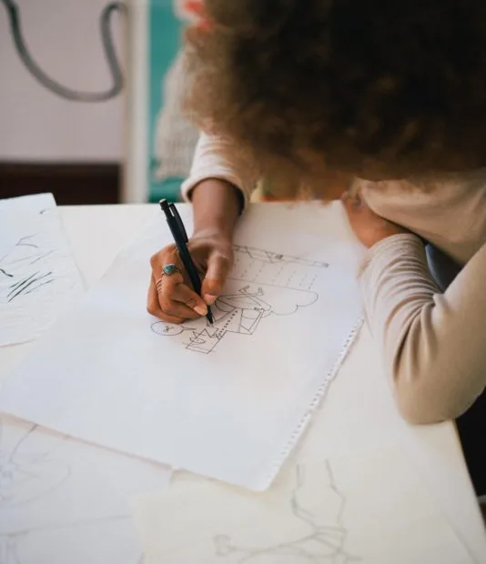 image of person drawing on paper - courtesy of Retha Ferguson
