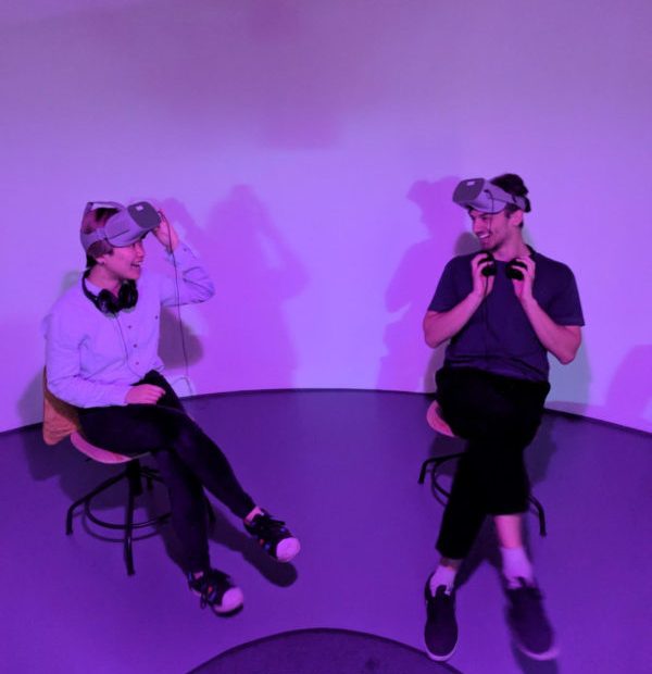 two people sat wearing VR Headsets