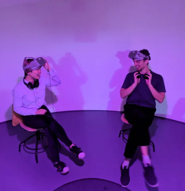 two people sat wearing VR Headsets