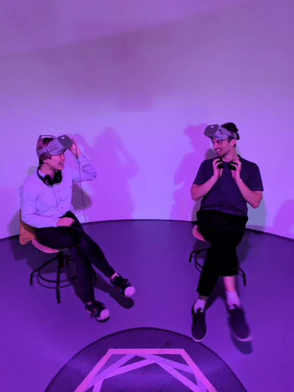 two people sat wearing VR Headsets
