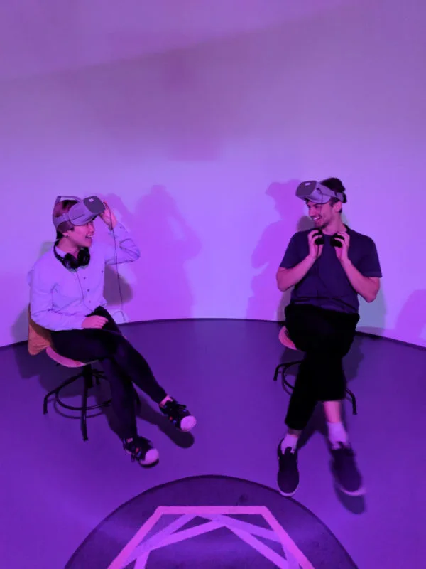two people sat wearing VR Headsets