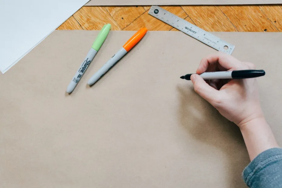 image of person writing with marker pens
