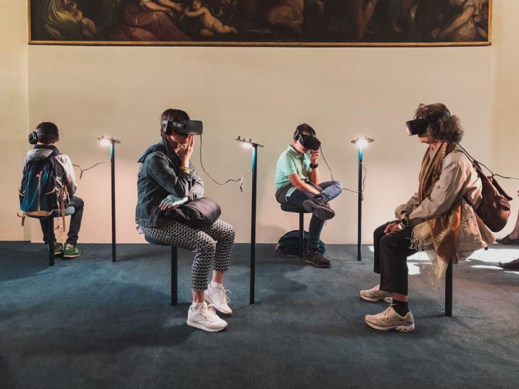 people sat in art gallery wearing VR Headsets