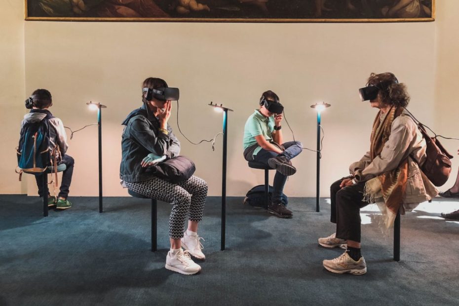 people sat in art gallery wearing VR Headsets