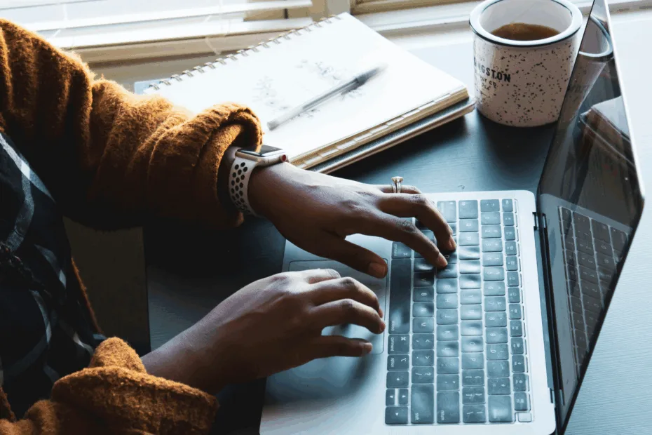 person typing on a laptop
