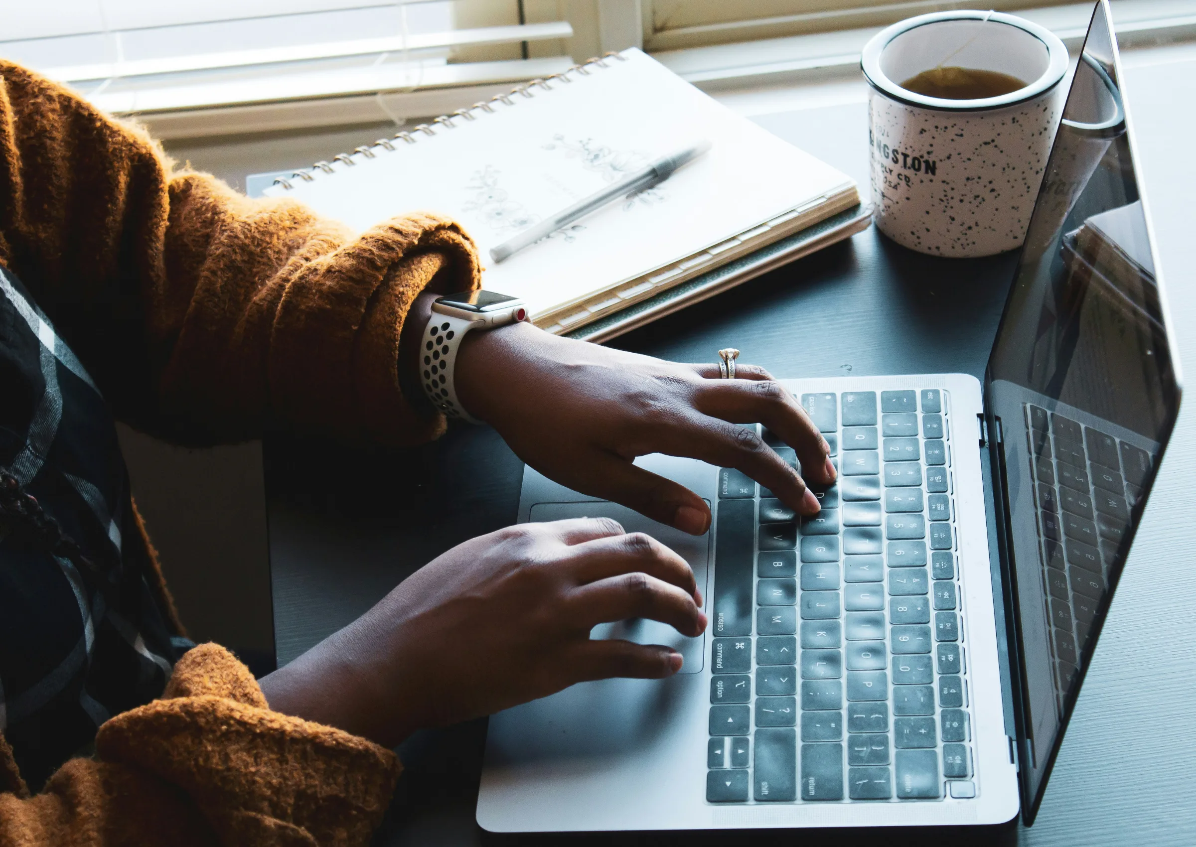 person typing on a laptop