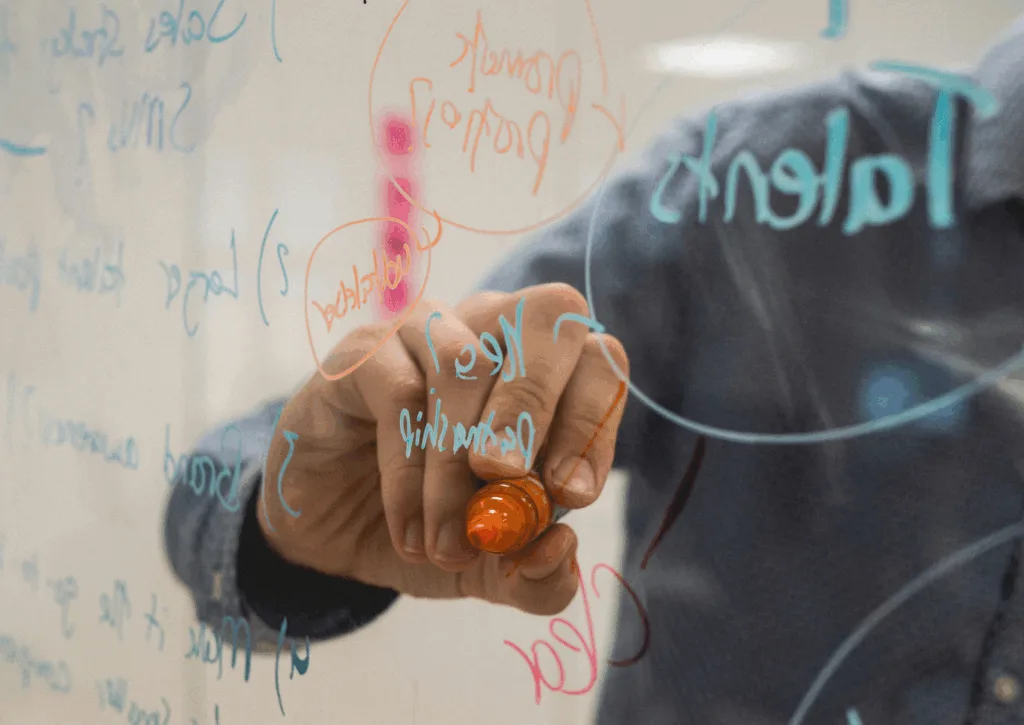 Man drawing with a marker pen on see-through panel