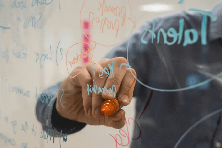 Man drawing with a marker pen on see-through panel