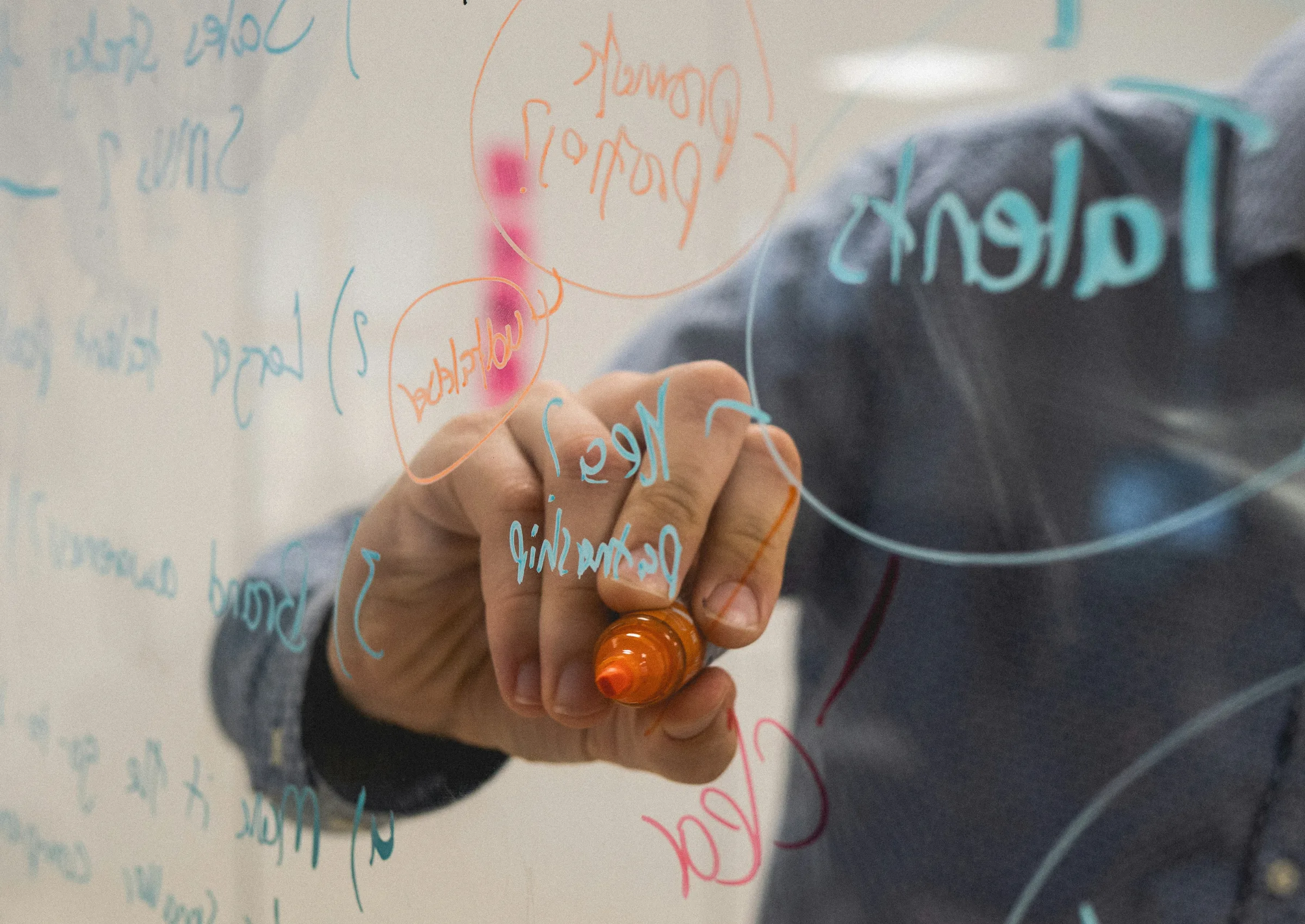Man drawing with a marker pen on see-through panel
